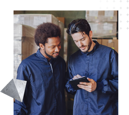 Two factory workers looking at tablet