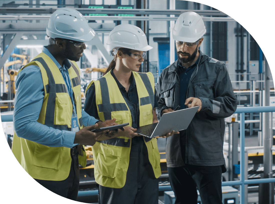 Three maintenance workers looking at laptop